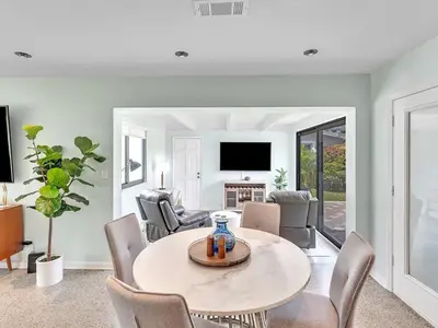 a living room with a table and chairs at Walk 2 Wilton! Heatd Pool & 10 min to Bch Las Olas in Fort Lauderdale
