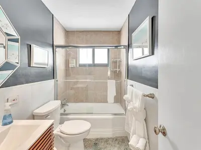 a bathroom with a tub and a toilet and a sink at Walk 2 Wilton! Heatd Pool & 10 min to Bch Las Olas in Fort Lauderdale