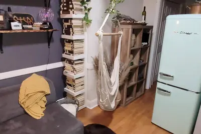 a living room with a couch and a refrigerator at The Cozy Villa-private parking in Miami