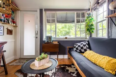 a living room with a blue couch and a table at The Cozy Villa-private parking in Miami
