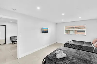 a bedroom with a bed in a white room at Beach And Hard Rock Hollywood Vacation House Ha02 in Hollywood