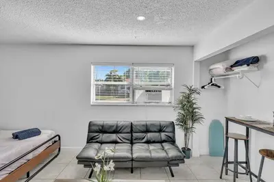 a living room with a couch and a bed at Large 2 Bed Studio Close to Beach & Hard Rock HA03 in Hollywood