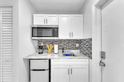 a white kitchen with a sink and a microwave at New 2 Bed Studio Close To Beach & Casino Ha04 in Hollywood