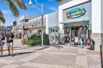 a man walking down a street in front of a store at New 2 Bed Studio Close To Beach & Casino Ha04 in Hollywood