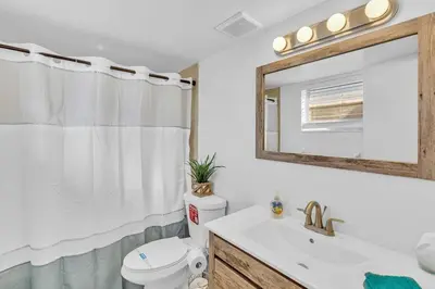 a bathroom with a toilet and a sink and a mirror at NEW 2 Bedroom Hollywood Beach and Hard Rock LB1 in Hollywood