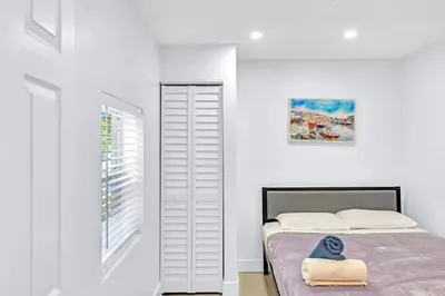 a white bedroom with a bed and a window at Hollywood 2 Bdrm New Furnished Beach Vacation LB2 in Hollywood