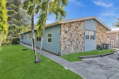 a house with a palm tree in front of it at Hollywood 2 Bdrm New Furnished Beach Vacation LB2 in Hollywood