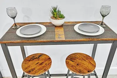 a table with two chairs and plates and wine glasses at Hollywood Large Studio Close to Beach & Casino LB3 in Hollywood