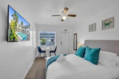 a bedroom with a bed and a ceiling fan at Waves On Desoto Rental Unit With Pool in Hollywood