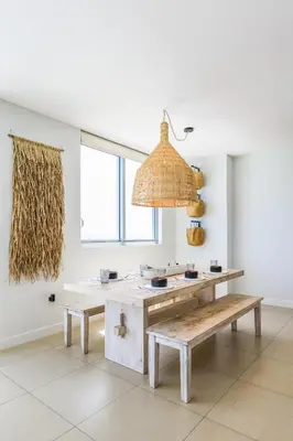 a room with a table and benches and a chandelier at Monte Carlo by Miami Vacations in Miami Beach