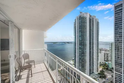a balcony with a chair and a view of the ocean at Deluxe 1 Bedroom Apartment • Brickell • Ocean View in Miami