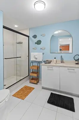 a bathroom with a shower and a sink and a toilet at Urban Retreat - Location Pool Gym & Parking in Miami