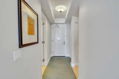 a hallway with a painting on the wall and a picture at Amazing private studio in Four Seasons Residences Brickell! in Miami