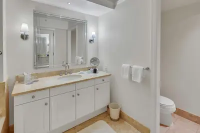 a bathroom with a sink and a toilet and a mirror at Amazing private studio in Four Seasons Residences Brickell! in Miami