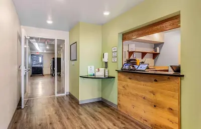 a kitchen with a counter in a room with green walls at Extended Stay America Select Suites - Fort Lauderdale - Airport - West in Davie