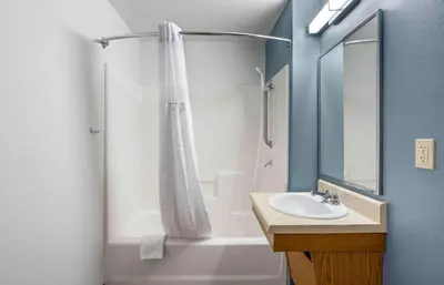 a bathroom with a shower curtain and a sink at Extended Stay America Select Suites - Fort Lauderdale - Airport - West in Davie