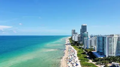 a view of a beach with buildings and the ocean at Beach Bae -Deco Studio Steps from the Ocean in Miami Beach
