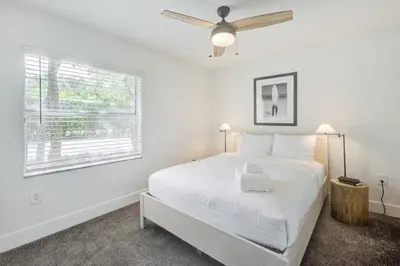 a white bedroom with a bed and a window at Tucker at Palm Trace Landings Fort Lauderdale in Davie