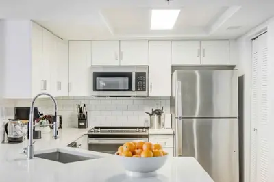 a kitchen with a bowl of oranges on a counter at Tucker at Palm Trace Landings Fort Lauderdale in Davie
