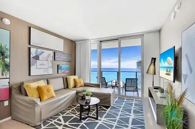 a living room with a couch and a table at Oceanfront Balcony - Endless Views - Amazing Pools in Hollywood