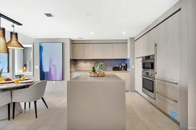 a kitchen with a counter and a dining room at Oceanfront Balcony - Endless Views - Amazing Pools in Hollywood