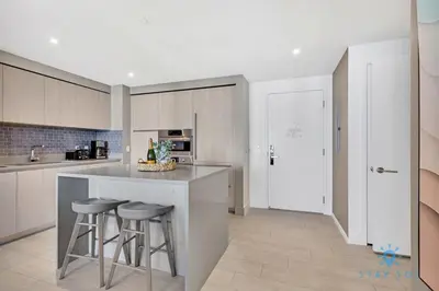 a kitchen with a counter and stools in it at Oceanfront Balcony - Endless Views - Amazing Pools in Hollywood