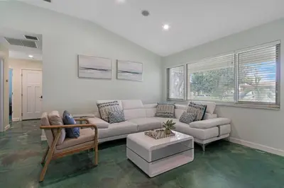 a living room with a couch and a table at Heated Pool I Soundproof Home I Firepit I 630Mbps in Hollywood