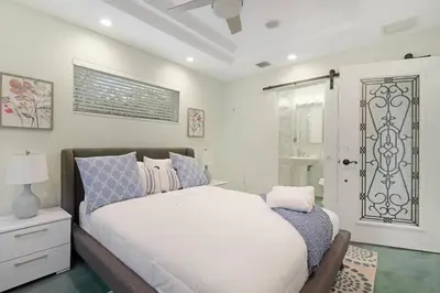a bedroom with a large white bed and a window at Heated Pool I Soundproof Home I Firepit I 630Mbps in Hollywood