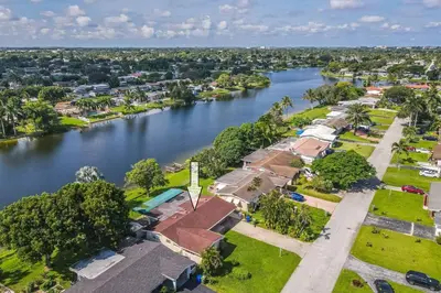 an aerial view of a house next to a river at Private Lakefront Home in Miami/Pembroke in Pembroke Pines