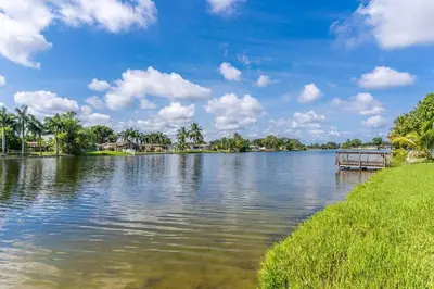a view of a lake with a dock at Private Lakefront Home in Miami/Pembroke in Pembroke Pines