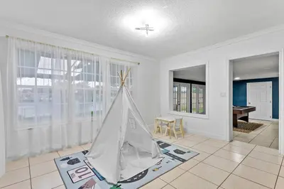 a living room with a toy tent on the floor at Private Lakefront Home in Miami/Pembroke in Pembroke Pines