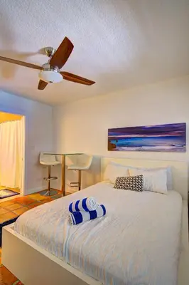 a bedroom with a bed with a ceiling fan at Efficiency 3 on water Las Olas beach and free kayaks in Fort Lauderdale