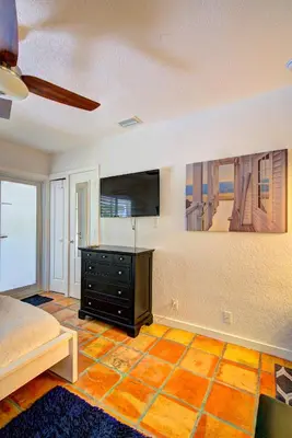 a bedroom with a bed and a tv on a wall at Efficiency 3 on water Las Olas beach and free kayaks in Fort Lauderdale