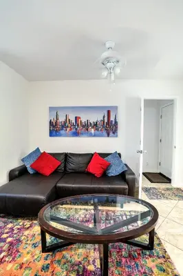 a living room with a leather couch and a glass table at A 1bedroom Las Olas on the water in Fort Lauderdale