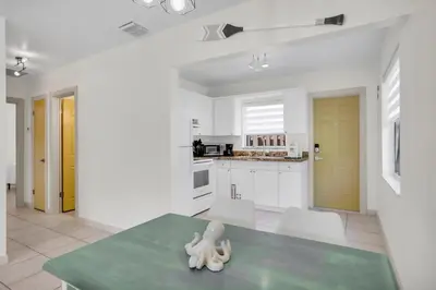 a white kitchen with a figurine on a table at LoKal Rental Tropical Florida destination in Fort Lauderdale