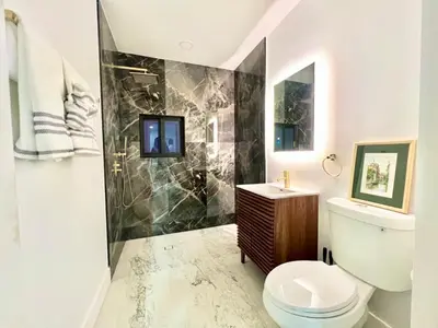 a bathroom with a toilet and a sink and a shower at 3 Seasons at the Carrington 3 Two Bedroom 1 Bath Apts -6 Bedrooms 3 bathrooms and 3 bedroom 2 bathroom Villa in Miami