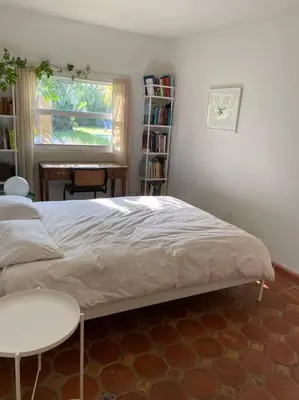 a bedroom with a bed and a table and a desk at Miami guest house with large pool in Miami