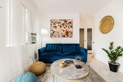 a living room with a blue couch and a table at Full 1BR Apt Close Downtown with Free Parking in Miami