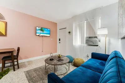 a living room with a blue couch and a table at Full 1BR Apt Close Downtown with Free Parking in Miami
