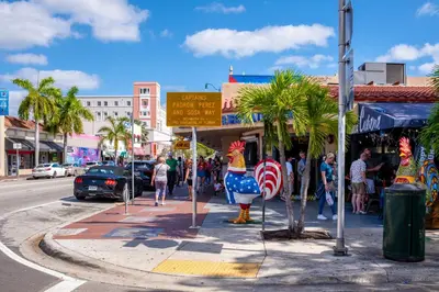 a group of people walking down a street next to a sidewalk at Full 1BR Apt Close Downtown with Free Parking in Miami