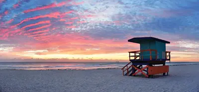 a lifeguard tower on the beach at sunset at Full 1BR Apt Close Downtown with Free Parking in Miami
