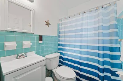 a blue and white bathroom with a toilet and a sink at Bright and Airy Miami 1BR Apt Near Brickell in Miami