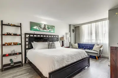 a bedroom with a bed and a couch and a chair at Modern Ft Lauderdale Condo about 7 Mi to Airport! in Fort Lauderdale