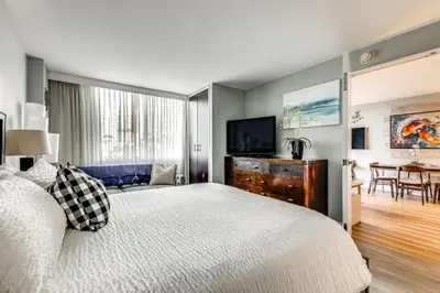 a bedroom with a bed and a flat screen tv at Modern Ft Lauderdale Condo about 7 Mi to Airport! in Fort Lauderdale