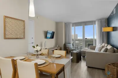 a living room with a table and a couch at Pool - Gym - Balcony - Amazing View - Near Beach in Hallandale Beach