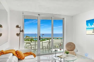 a living room with a couch and a view of the ocean at Special Offer - Balcony - Beachfront Condo - Gym in Hollywood