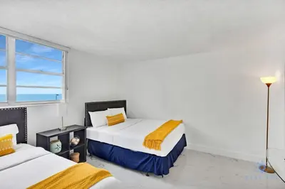 a bedroom with two beds and a window at Special Offer - Balcony - Beachfront Condo - Gym in Hollywood