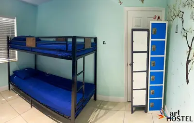 two bunk beds in a room with blue walls at Summer Gardens in Miami