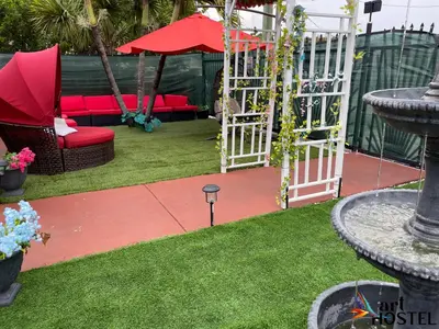 a garden with a red couch and a swing at Summer Gardens in Miami