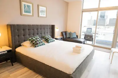 a bedroom with a large bed with a large window at Rooftop-Pool Suite with King Bed in Ocean Dr C303 in Miami Beach